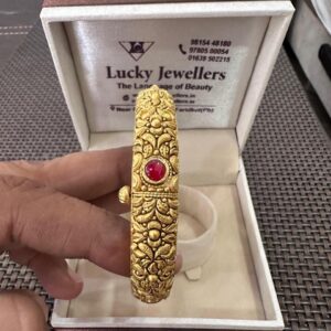 Gold Designer Bangle with Red Stone Centerpiece