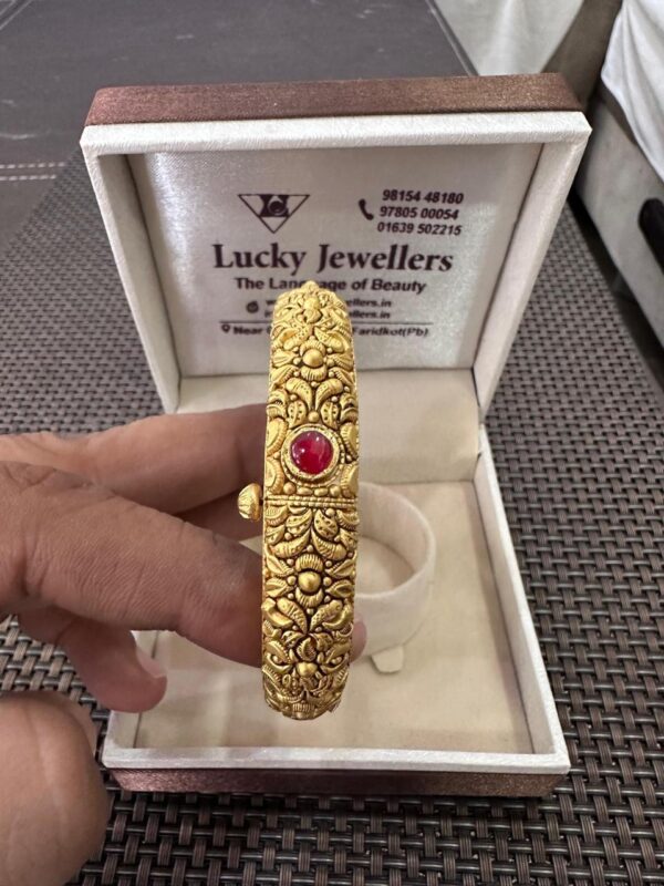 Gold Designer Bangle with Red Stone Centerpiece